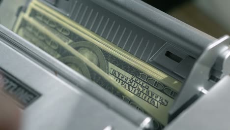 machine counter automatic calculates a large amount of dollar banknotes in 4k slow motion 60fps