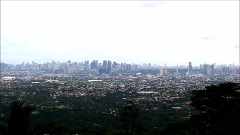 steady extreme long video shot of a cityscape of several towns in metro manila, philippines as seen from a high vantage point on a mountain