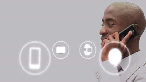 animation of icons and data processing over african american businessman in office