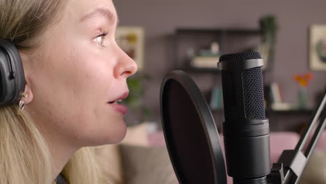 close up view of woman recording a podcast wearing headphones 2