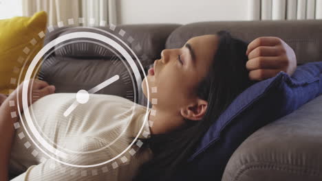 animation of moving clock over biracial woman laying on sofa