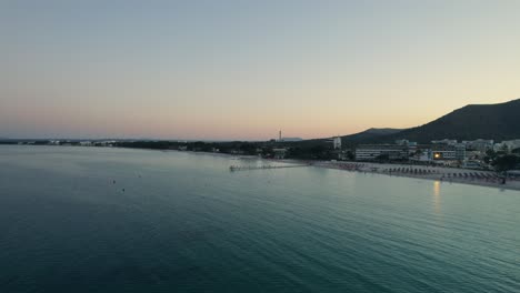 drone aerial video on palma de mallorca island coastline at dawn with panoramic view of hotel complexes while city wakes up