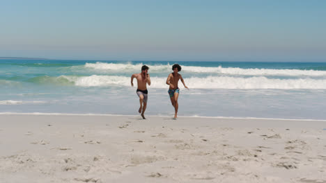 Young-male-friends-running-towards-sea-4k