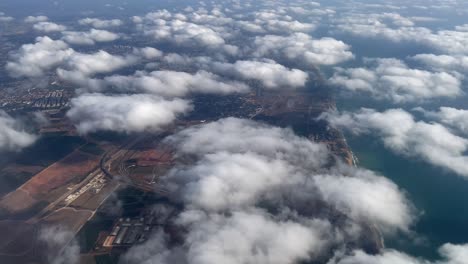 aerial view of israeli coastal city and farmland with clouds