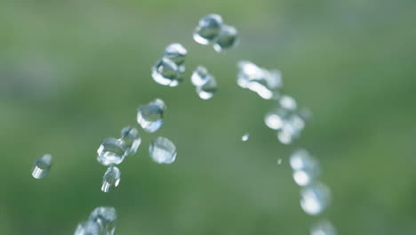 Pure-water-droplets-passing-camera-in-Slowmotion-with-green-background---180fps