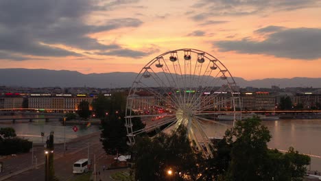 sunset sky night illumination geneva city center traffic ferris wheel aerial panorama 4k switzerland