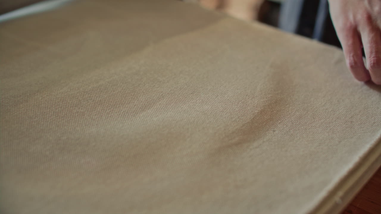Hands of Female Potter Checking Freshly Rolled Clay Disc on Canvas Sheet