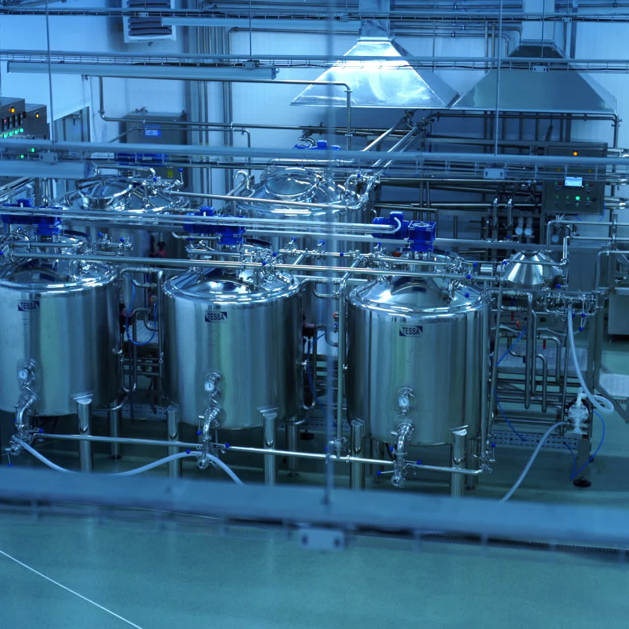 Top view on the modern milk factory indoors. Contemporary equipment for making cheese inside the dairy manufacturing plant.