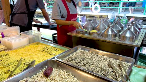 vendor preparing food at bustling market stall