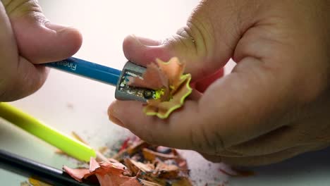 Footage-of-hands-slowly-sharpening-a-pencil-and-some-coloured-pencils-with-a-Wedge-Pencil-Sharpener