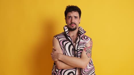 sad and worried gay man looking at the camera