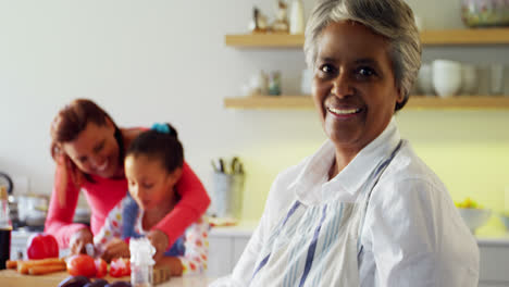 smiling grandmother holding recipe book in kitchen 4k