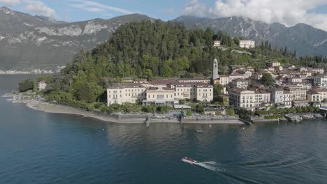 4k aerial - slow pull back from hotel in bellagio lake como, italy