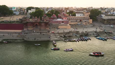 stunning aerial view of banaras, with the ganga river meandering through the bustling city at sunrise.