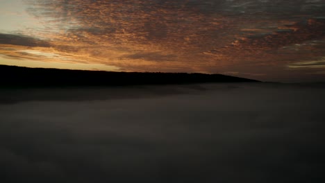 A-natural-spectacle:-Red-and-orange-sunset-over-fog-mist