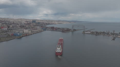aerial, cargo ship leaving duluth harbor in minnesota on an overcast day