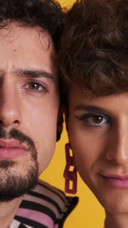 close up of gay couple in makeup looking at the camera