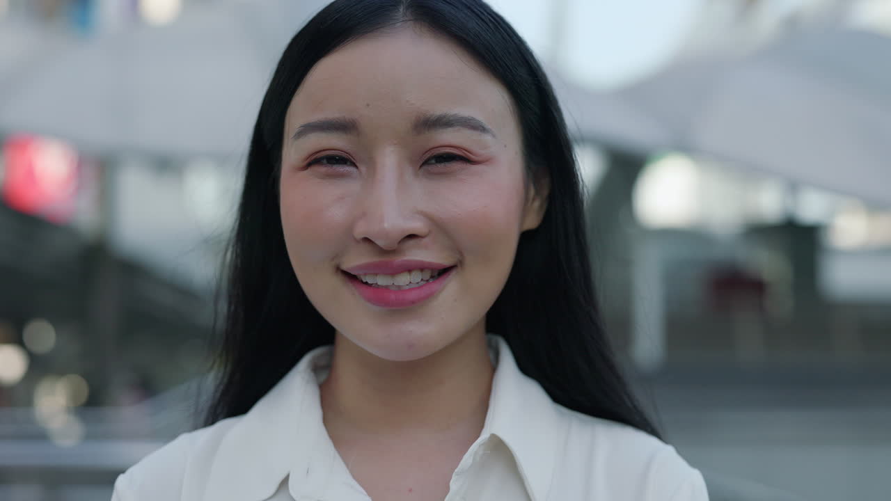 Close-up portrait of a smiling young Asian woman