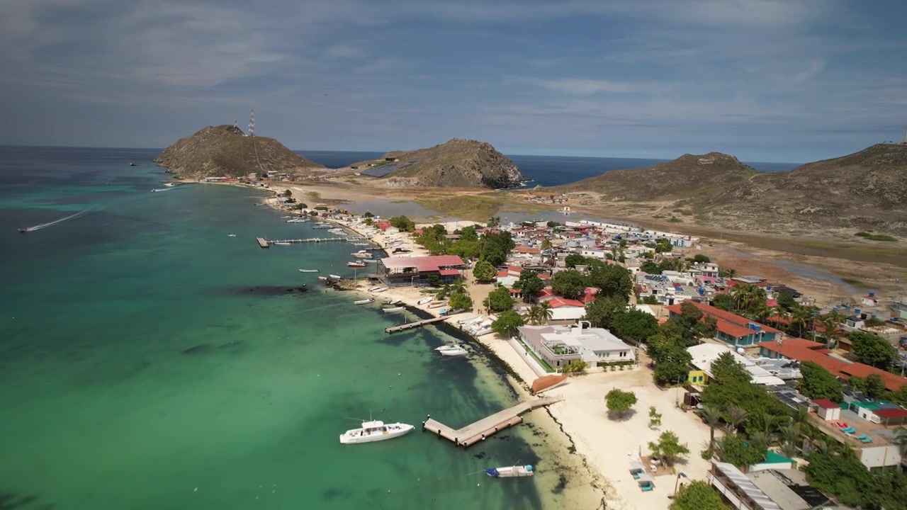 Acque turchesi, spiagge sabbiose e una colorata cittadina costiera a Gran Roque a Los Roques, vista aerea.