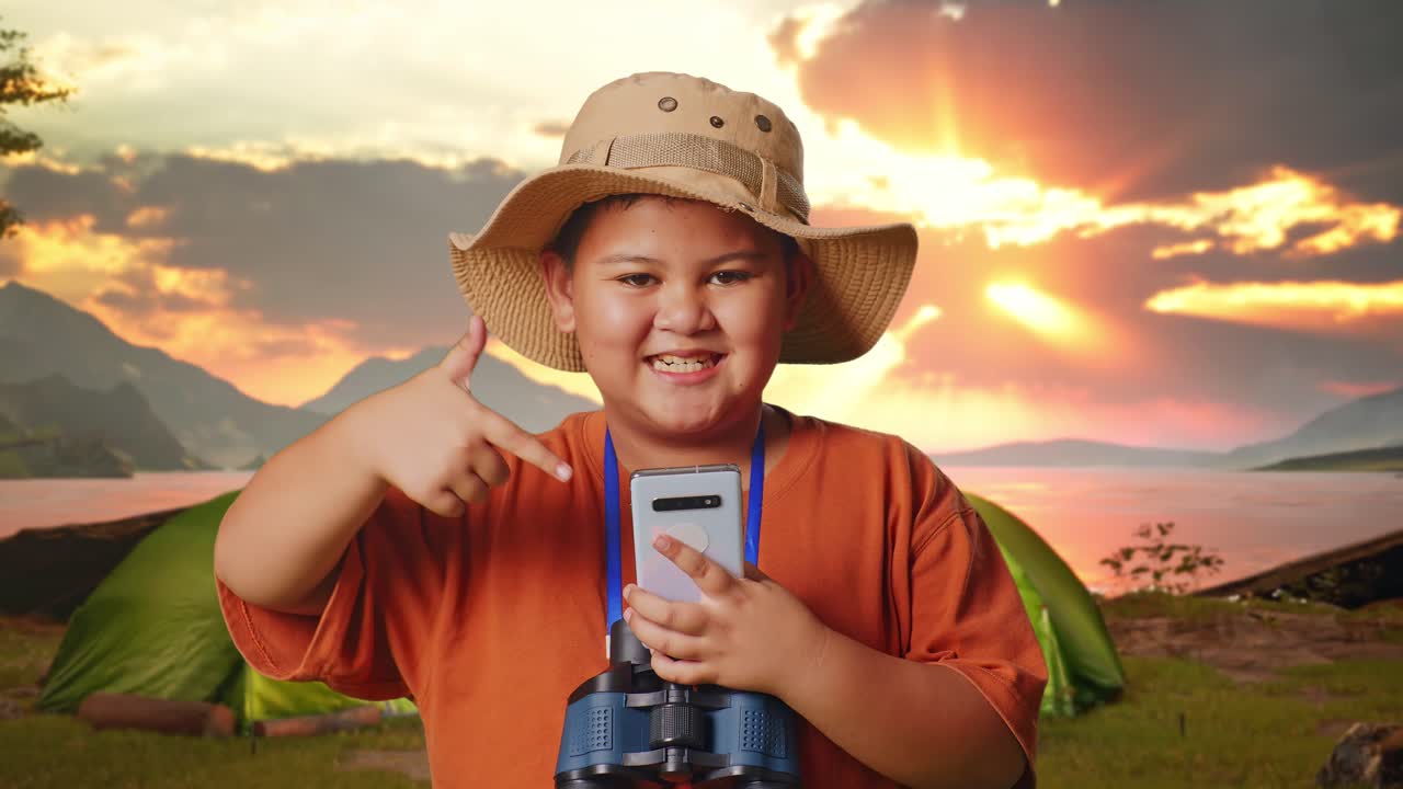 Happy Kid Exploring Nature with a Smartphone and Binoculars