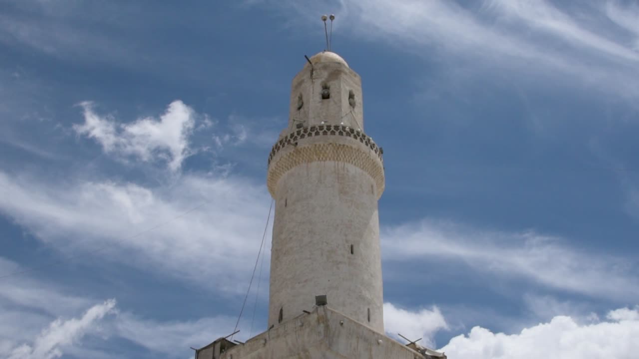 Old Sana'a City Grand mosque white minaret low angle with clouds and sky