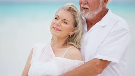 senior caucasian couple sharing kiss on tropical beach