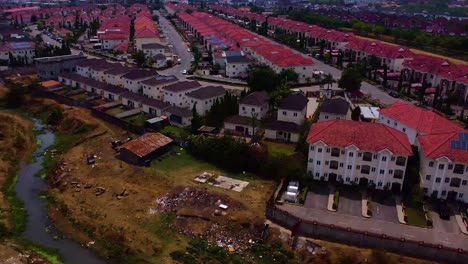urban calm near riverbed in lifecamp estate as drone quietly descends overhead