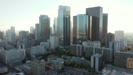 Slow-tilt-up-revealing-huge-City-skyline-with-multiple-Towers-and-Office-Buildings,-Scenic-Aerial-Dolly-in