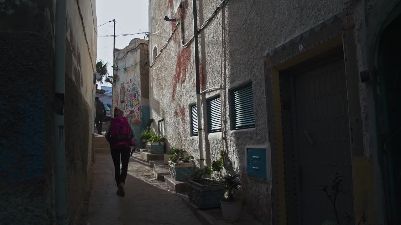 Tourists walking in an alley in Taghazout