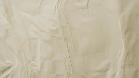 video of close up of yellow creased fabric with copy space