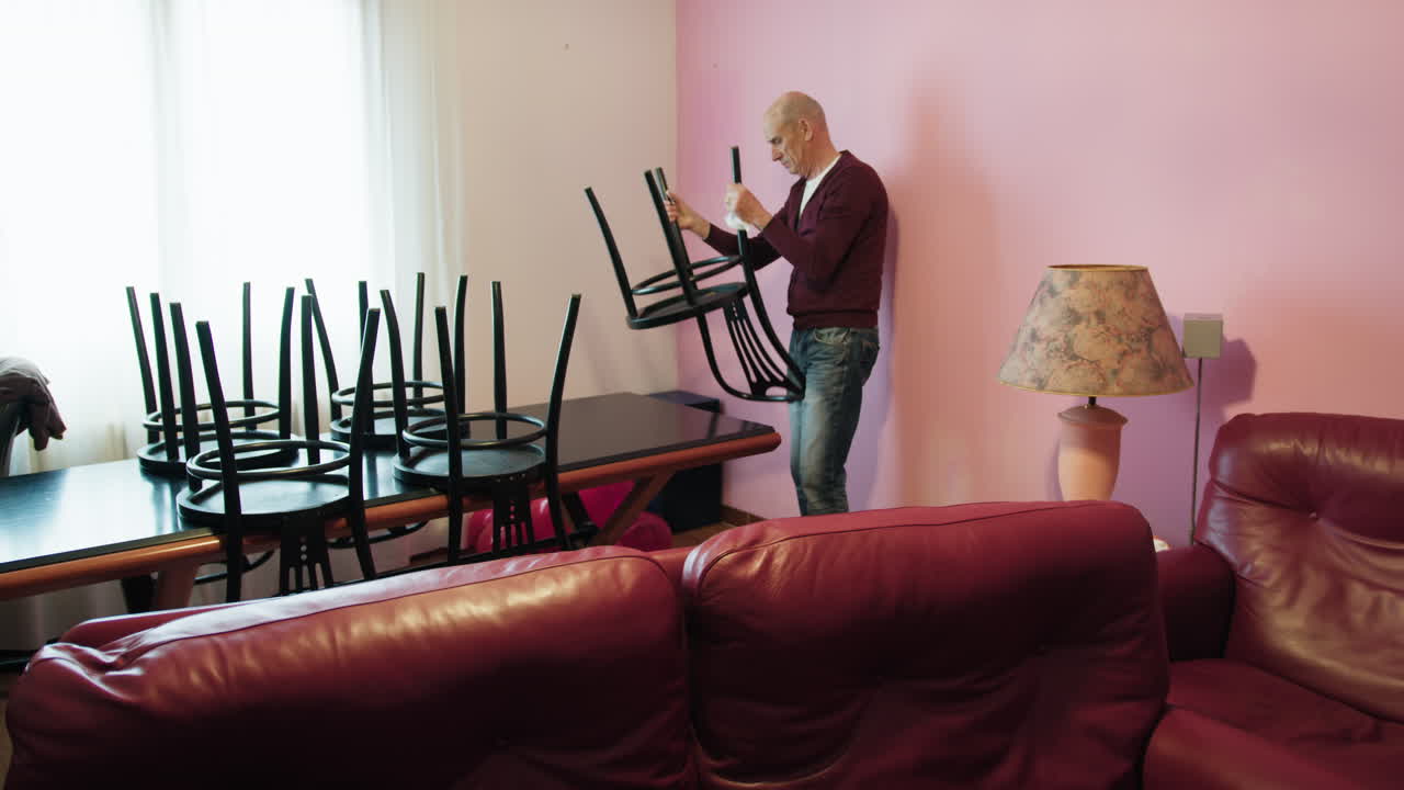 Man moving furniture in a room