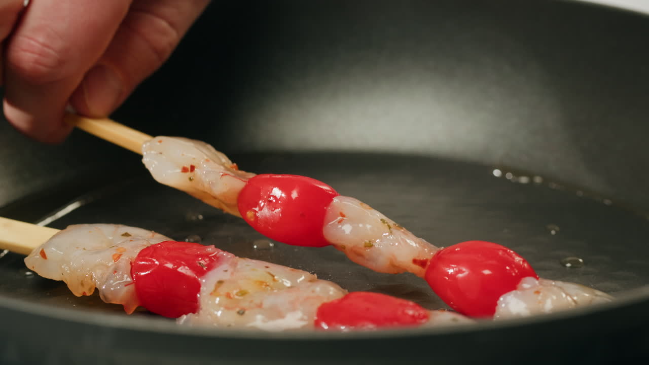 Preparing Shrimp and Tomato Skewers in a Pan