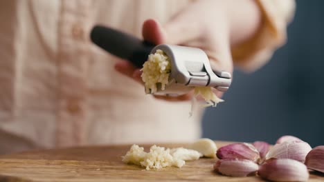 Close-up-of-garlic-clove-and-garlic-press.