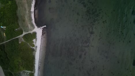 aerial topdown of beach and ocean at sunset