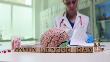 world stroke day awareness concept with brain model and medical professional