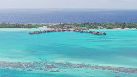 bora bora island lagoon and luxury resort with overwater bungalows, french polynesia, drone shot