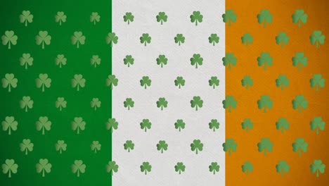 animación digital de varias hojas de trébol que se mueven contra la bandera irlandesa