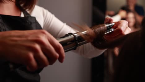 hairstylist curling hair