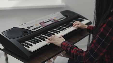 hands playing electric keyboard close up 1