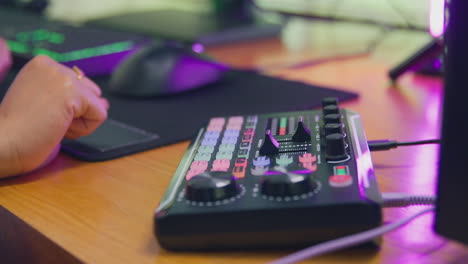 close up of female vlogger using editing console for live stream of channel