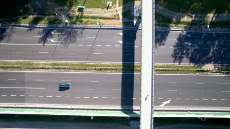 top down aerial over the fast-moving road - tracking a white truck with a trailer going from right to left on the outermost lane