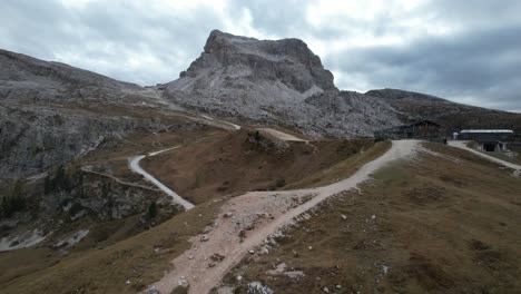 Drone-shot-of-path-leading-past-a-ski-lift-during-summer-to-a-mountain-dolomites-Italy-4K