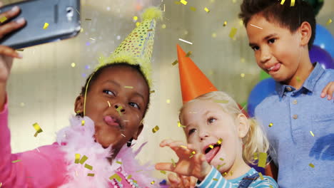 wearing party hats, children taking selfie with confetti falling around them