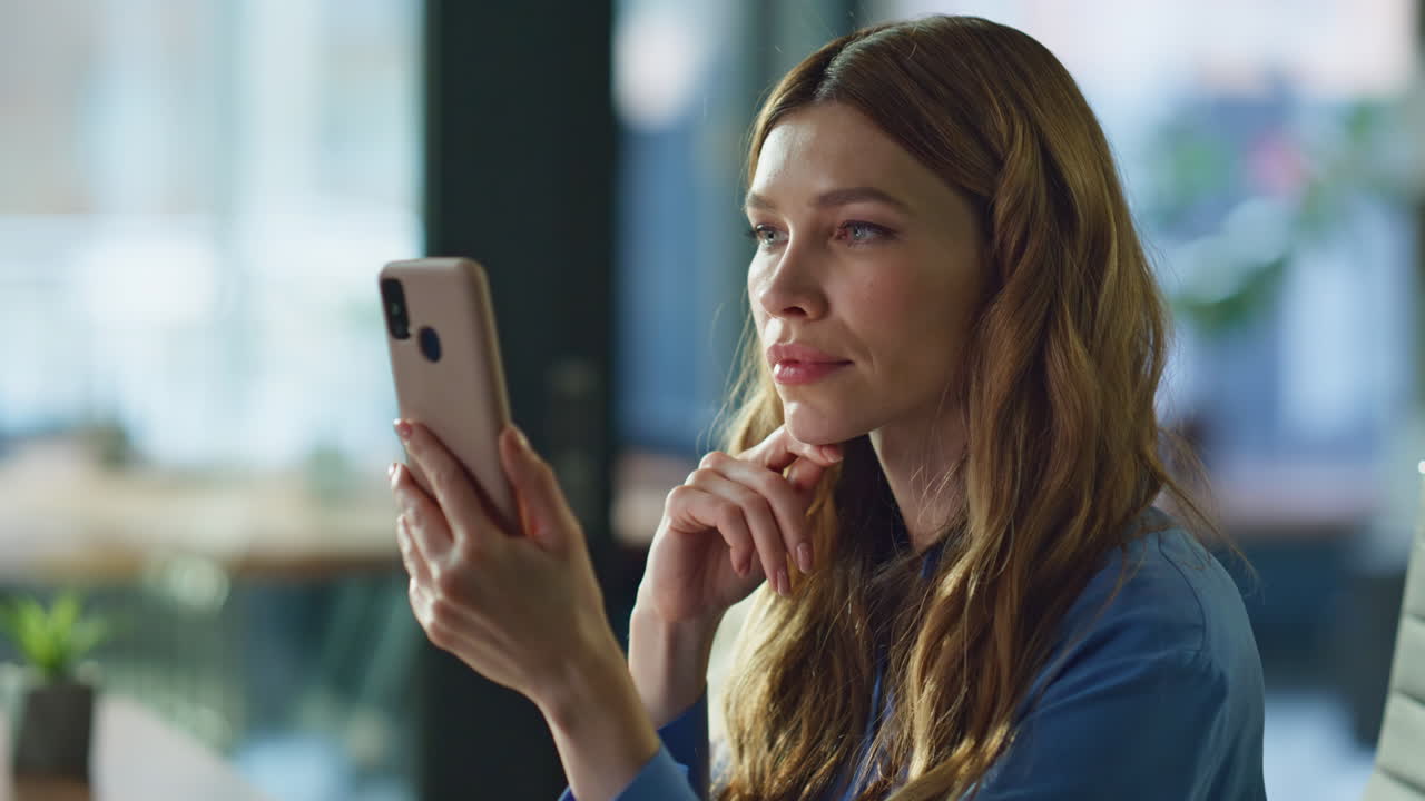 Confident lady scrolling cellphone sitting office closeup. Focused employee