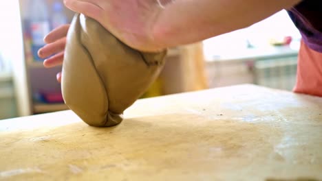 a creative journey: sculpting clay with hands to form unique artistic shapes in a bright and inviting workspace