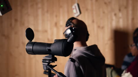 person analyzing targets shot using magnifying lens during firearm practice