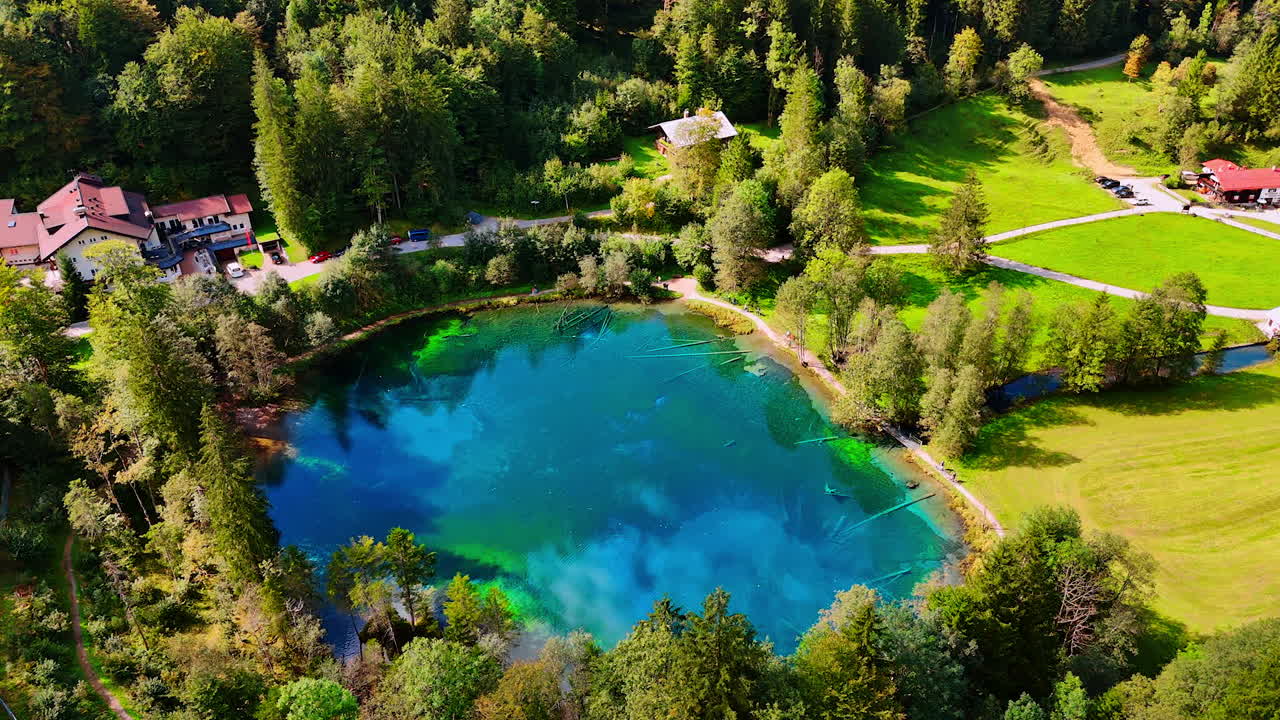 Approaching the Christlessee lake, Oberstdorf, Bavarian Alps, Europe. Stunning scenery of the picturesque valley with hotels from drone.