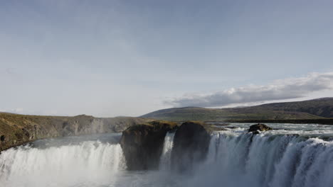 wide panoramic tilt down to reveal clip of the godafoss waterfalls in iceland - nature, adventure and majesty concepts