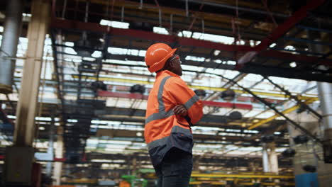 afro american supervisor thinking about project work at production warehouse.