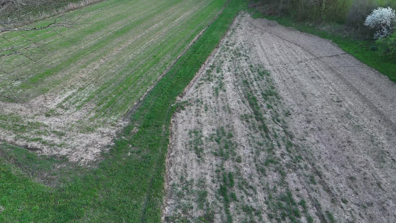 Aerial view of a forested landscape and a small village in spring